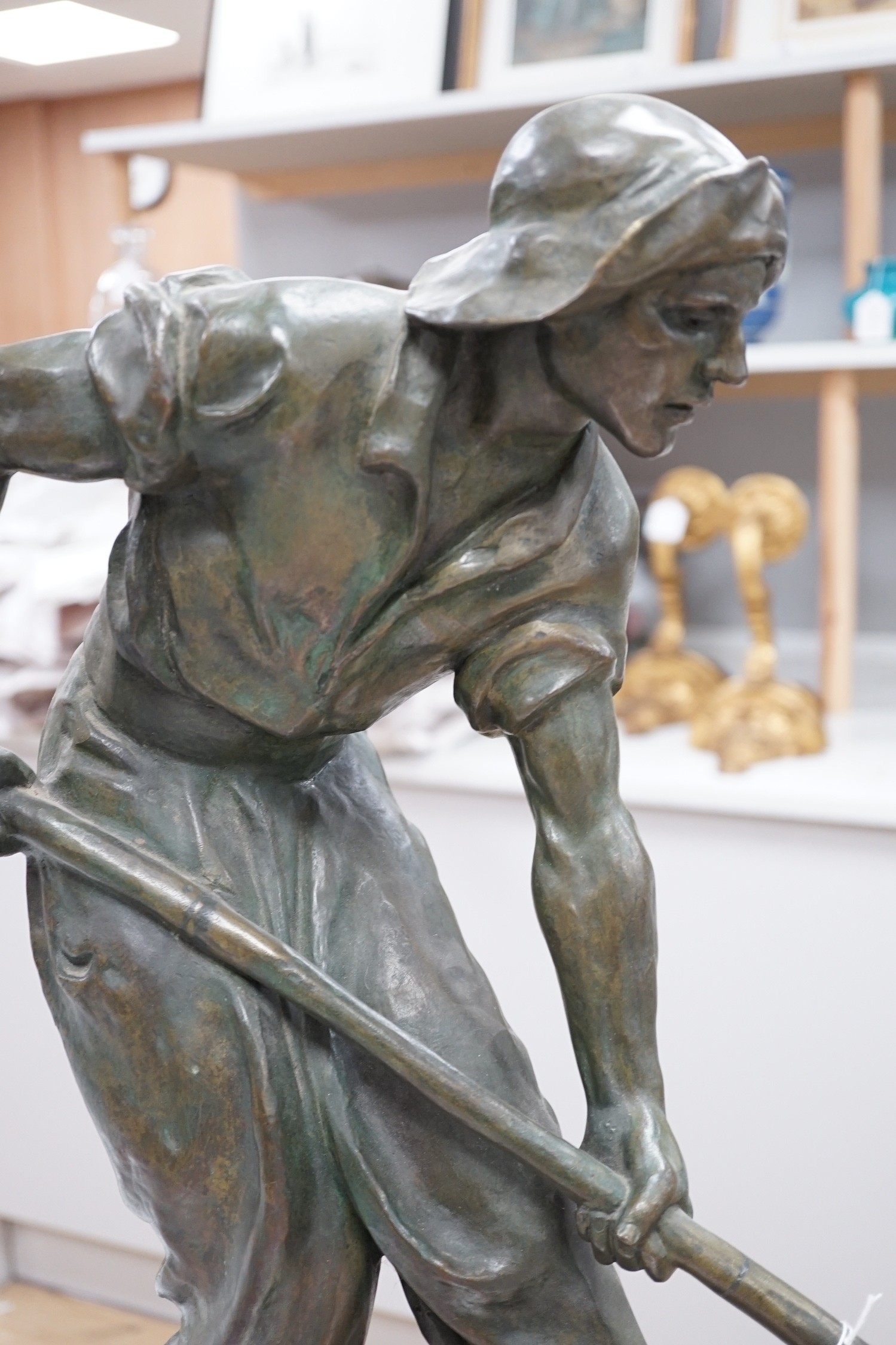 Amedeo Gennarelli (1881-1943). A bronze figure of a labourer shovelling seaweed , 'Le Ramasseur de Goemon', width 94cm height 52cm